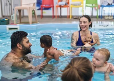 teacher-and-parents-teaching-infants-to-swim